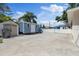 Spacious backyard with sheds and a white fence, providing ample space for outdoor activities and storage at 8310 Pat Blvd, Tampa, FL 33615