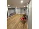 Spacious basement with laminate flooring, featuring rolls of carpet and modern red chairs at 8310 Pat Blvd, Tampa, FL 33615