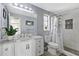 Updated bathroom features a white vanity with marble countertop and a modern tiled shower with a plant at 8310 Pat Blvd, Tampa, FL 33615