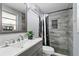 Contemporary bathroom with a gray vanity, a tiled shower, and modern fixtures at 8310 Pat Blvd, Tampa, FL 33615