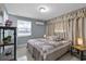 Cozy bedroom with a patchwork quilt, light-blocking curtains, and neutral color scheme at 8310 Pat Blvd, Tampa, FL 33615