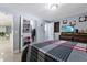 Bright bedroom featuring a flat-screen TV, and a convenient shoe organizer on the closet door at 8310 Pat Blvd, Tampa, FL 33615