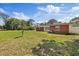 Well-maintained home with brick accents, showcasing a spacious front yard and landscaping at 8310 Pat Blvd, Tampa, FL 33615