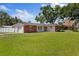 Inviting home with a brick facade, attached garage, and a spacious green front yard at 8310 Pat Blvd, Tampa, FL 33615