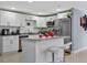 Bright kitchen with white cabinets, stainless steel appliances, and a center island with seating at 8310 Pat Blvd, Tampa, FL 33615