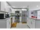 Well-lit kitchen featuring stainless steel appliances, white cabinets, and granite countertops with a decorative sunflower mat at 8310 Pat Blvd, Tampa, FL 33615