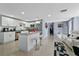 Stylish living area with a kitchen island, white cabinets, and contemporary decor at 8310 Pat Blvd, Tampa, FL 33615