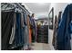 Organized walk-in closet with shelving, hanging clothes, and black dresser, offering ample storage space at 8310 Pat Blvd, Tampa, FL 33615