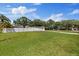 Expansive backyard enclosed by a white fence, offering privacy and ample space for recreation at 8310 Pat Blvd, Tampa, FL 33615