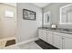 Well-lit bathroom boasts double vanities with granite countertop, illuminated mirrors, and a linen closet at 9316 Crescent Ray Dr, Wesley Chapel, FL 33545