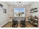 Charming dining area features a stylish light fixture, and decorative shelving with a window view at 9316 Crescent Ray Dr, Wesley Chapel, FL 33545