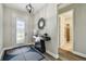 Welcoming entryway features a modern console table, stylish rug, and decorative light fixture at 9316 Crescent Ray Dr, Wesley Chapel, FL 33545
