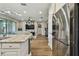 Open-concept kitchen flows into the living area featuring stainless steel appliances at 9316 Crescent Ray Dr, Wesley Chapel, FL 33545