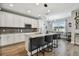 Modern kitchen boasts granite countertops, stainless steel appliances, and a stylish island with seating at 9316 Crescent Ray Dr, Wesley Chapel, FL 33545