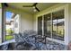 Screened lanai with outdoor seating area, fan, and backyard scenery at 9316 Crescent Ray Dr, Wesley Chapel, FL 33545