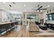 Open-concept living space with modern decor, natural light, and access to the outdoor patio at 9316 Crescent Ray Dr, Wesley Chapel, FL 33545