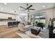 Open-concept living space with modern decor, natural light, and access to the outdoor patio at 9316 Crescent Ray Dr, Wesley Chapel, FL 33545
