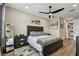 Comfortable main bedroom features a ceiling fan, wood floors, and stylish decor at 9316 Crescent Ray Dr, Wesley Chapel, FL 33545