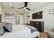 Relaxing main bedroom showcasing dark wood furnishings, wood floors, and a media center at 9316 Crescent Ray Dr, Wesley Chapel, FL 33545