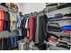 Spacious walk-in closet with ample hanging and shelf storage at 9316 Crescent Ray Dr, Wesley Chapel, FL 33545