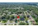 An aerial view of the property, highlighting its location in a neighborhood with mature trees and well-maintained homes at 9403 Bellhaven St, Temple Terrace, FL 33637