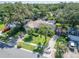 An aerial view of a well-maintained home with a manicured lawn and mature landscaping in a quiet neighborhood at 9403 Bellhaven St, Temple Terrace, FL 33637