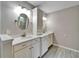 Bathroom with a white vanity with double sinks, stylish mirrors, and plenty of cabinet space at 9403 Bellhaven St, Temple Terrace, FL 33637