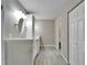 Bathroom featuring a white vanity with dual sinks, modern lighting, and a closet space at 9403 Bellhaven St, Temple Terrace, FL 33637