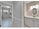 Hallway view into bathroom with neutral walls, tile flooring and updated vanity at 9403 Bellhaven St, Temple Terrace, FL 33637