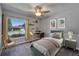 Charming bedroom with gray walls, ceiling fan, area rug, and a bright window at 9403 Bellhaven St, Temple Terrace, FL 33637