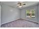 Bedroom with gray walls, carpet flooring, natural light, and a ceiling fan at 9403 Bellhaven St, Temple Terrace, FL 33637