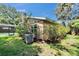 Side view of a well-maintained home with a charming pool and lush landscaping at 9403 Bellhaven St, Temple Terrace, FL 33637