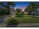 A charming single-story home featuring a well-manicured lawn, mature landscaping, and a welcoming facade at 9403 Bellhaven St, Temple Terrace, FL 33637