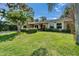 Well-maintained lawn and landscaping enhance the curb appeal of this lovely single-story home at 9403 Bellhaven St, Temple Terrace, FL 33637