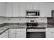 Kitchen area featuring a stainless steel oven, range, and microwave, with granite countertops at 9403 Bellhaven St, Temple Terrace, FL 33637