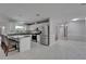 Open kitchen featuring an eat in kitchen island with white cabinets, stainless steel appliances, and granite countertops at 9403 Bellhaven St, Temple Terrace, FL 33637