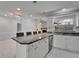 Kitchen featuring a sink, dishwasher, and island with granite countertops and stainless steel appliances at 9403 Bellhaven St, Temple Terrace, FL 33637