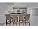 Open kitchen featuring an eat in kitchen island with white cabinets, stainless steel appliances, and granite countertops at 9403 Bellhaven St, Temple Terrace, FL 33637