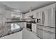 Kitchen featuring stainless steel appliances, granite countertops, with white cabinets at 9403 Bellhaven St, Temple Terrace, FL 33637