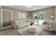 Bright living room featuring neutral tones, modern furniture, and a sliding door providing outdoor views at 9403 Bellhaven St, Temple Terrace, FL 33637
