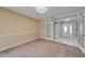 Living room with neutral walls, carpet flooring and view of foyer with decorative glass entry door at 9403 Bellhaven St, Temple Terrace, FL 33637