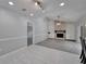 Living room with stone fireplace, wood floors, and gray tile leading into the kitchen at 9403 Bellhaven St, Temple Terrace, FL 33637