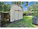 Backyard featuring a shed, manicured lawn, and a pool enclosure, great for outdoor living at 9403 Bellhaven St, Temple Terrace, FL 33637
