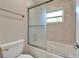 Bright bathroom featuring a shower with sliding glass door and a bathtub at 9403 Bellhaven St, Temple Terrace, FL 33637