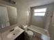 This bathroom features a vanity with a sink and a tub with shower at 9411 Rainbow Ln, Port Richey, FL 34668