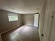 This bedroom features tile flooring and a window letting in natural light at 9411 Rainbow Ln, Port Richey, FL 34668