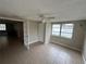 Versatile bonus room with natural light, tile flooring, and a ceiling fan, ready for any purpose from office to gym at 9411 Rainbow Ln, Port Richey, FL 34668