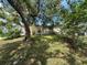 This home features mature landscaping providing shade and privacy at 9411 Rainbow Ln, Port Richey, FL 34668