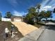 Single-story home boasts a driveway and well-maintained front yard with mature landscaping at 9411 Rainbow Ln, Port Richey, FL 34668