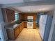 Functional kitchen featuring wooden cabinets, granite countertops, and appliances; ideal for cooking enthusiasts at 9411 Rainbow Ln, Port Richey, FL 34668
